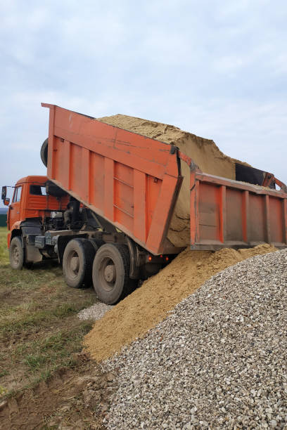 istock A dump truck unloads sand at a construction site. 2157790184