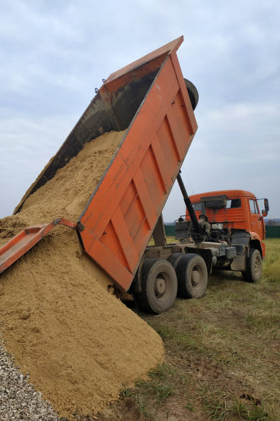 istock A dump truck unloads sand at a construction site. 2157790187