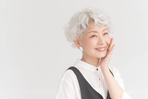 istock An elderly Asian woman is putting her hand on her cheek. 2157790337