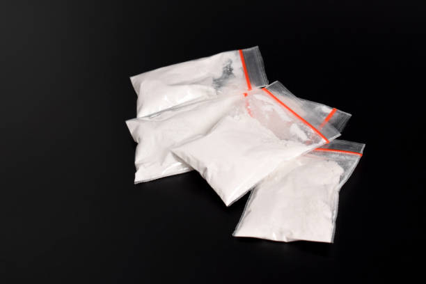 istock Cocaine in plastic packet on black background. illegal drugs 2157792654