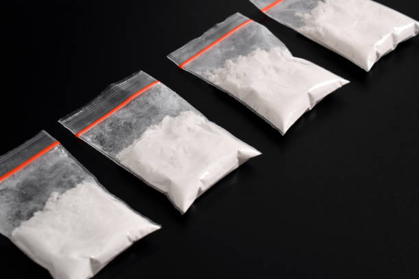 istock Cocaine in plastic packet on black background. illegal drugs 2157792791