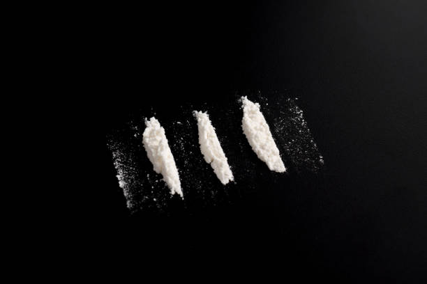 istock Lines of cocaine isolated on black backgound 2157792875