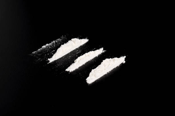 istock Cocaine powder in three lines on black background 2157792879