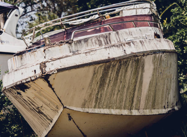 istock Old and rusty motor boats on a landfill surrounded by tropical forest 2157793547