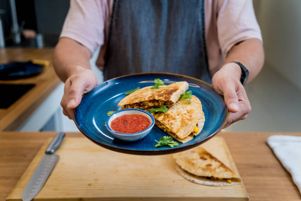 istock Chef at the kitchen preparing quesadillas with tofu and sweet corn 2157795878