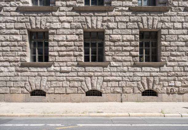 istock sidewalk and facade of a historic stone building with large rectangular windows 2157796325