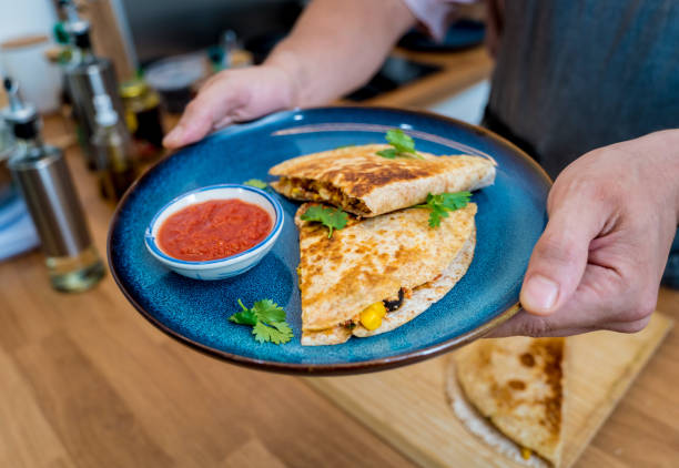 istock Chef at the kitchen preparing quesadillas with tofu and sweet corn 2157796432