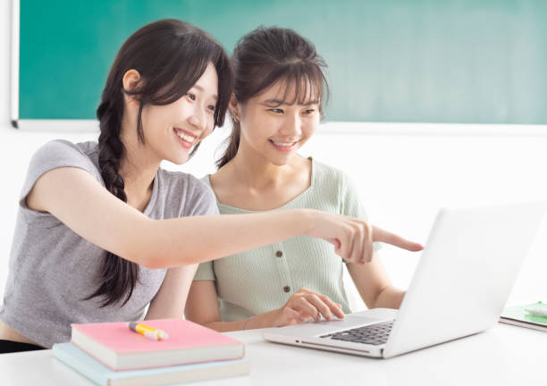 Two students studying together and watching the laptop