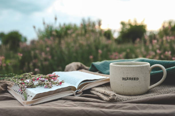 istock Cup with text BLESSED and open Bible in the garden, good morning 2157801451