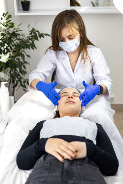 istock An experienced cosmetologist, beautician performs a relaxing facial massage for the client to prepare the skin for a cosmetic procedure, promoting deep relaxation and hydration. 2157802010