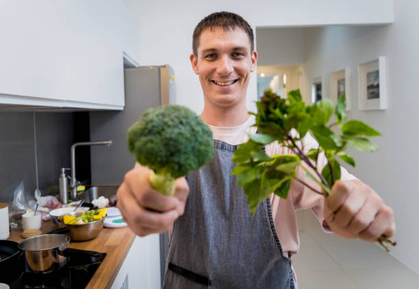 istock Chef at the kitchen preparing green curry with herbs and rice 2157802124
