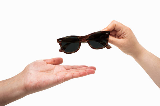 istock giving a sunglasses to another 2157804210