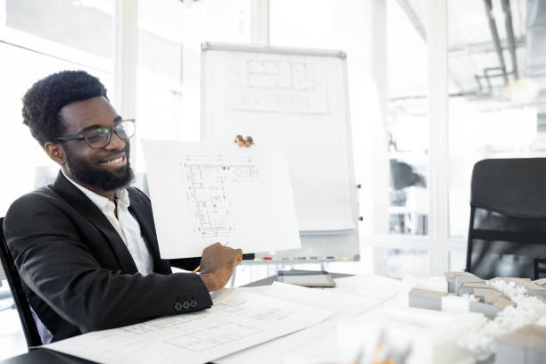 Successful businessman. Smiling and successful dark-skinned businessman in his office