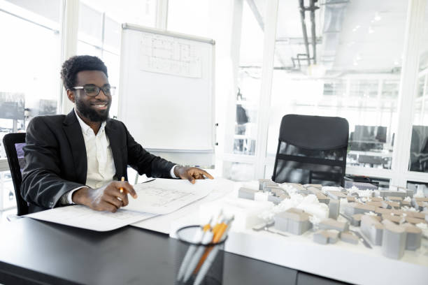 Successful businessman. Smiling and successful dark-skinned businessman in his office
