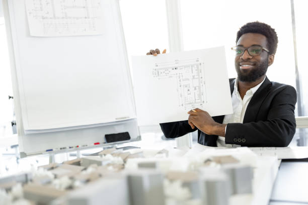 Successful businessman. Smiling and successful dark-skinned businessman in his office