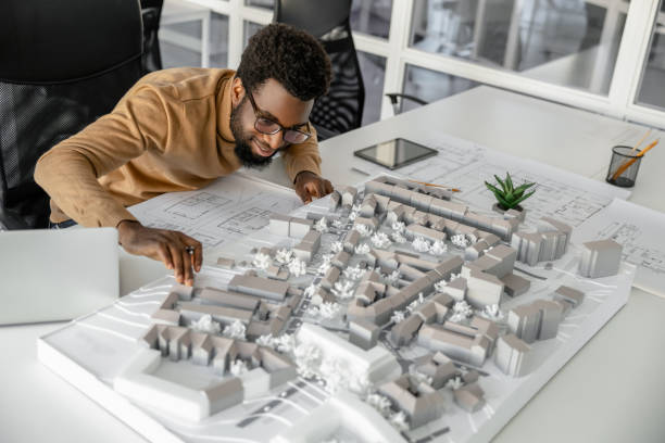 Architect working on miniature project and looking inspired Inspiration. Architect working on miniature project and looking inspired african american architecture stock pictures, royalty-free photos & images
