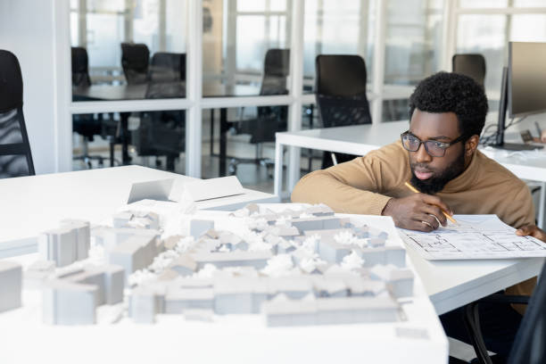 istock African american architect thinking on a miniature and looking thoughtful 2157806460
