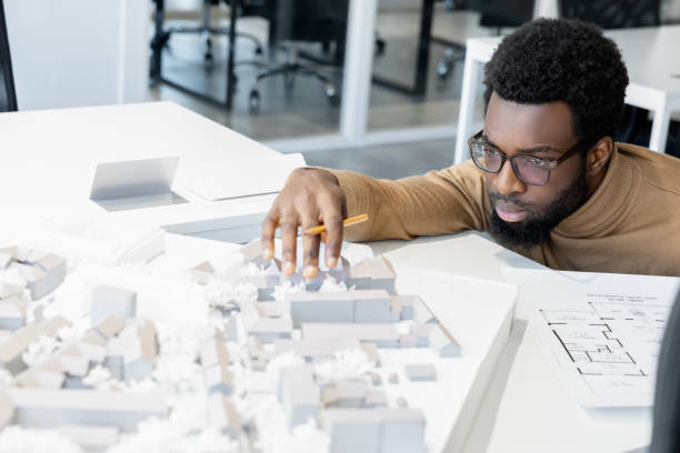 istock African american architect thinking on a miniature and looking thoughtful 2157806461