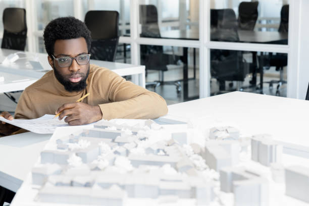 istock African american architect thinking on a miniature and looking thoughtful 2157806464