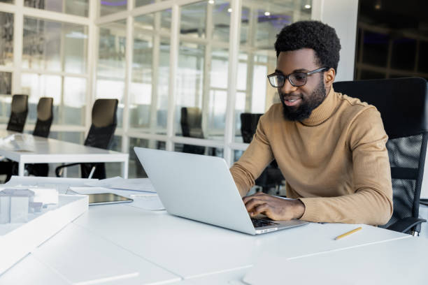 istock African american young man working in the office and looking busy 2157806473