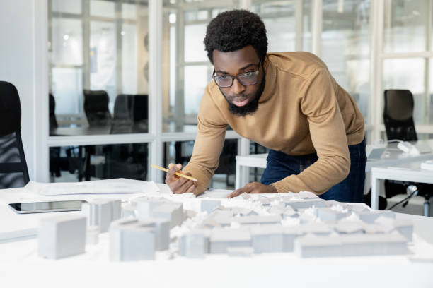 istock African american architect thinking on a miniature and looking thoughtful 2157806484