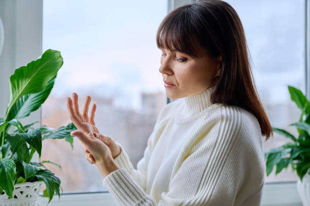 istock Middle aged woman suffering from pain in hand wrist joint 2157806559