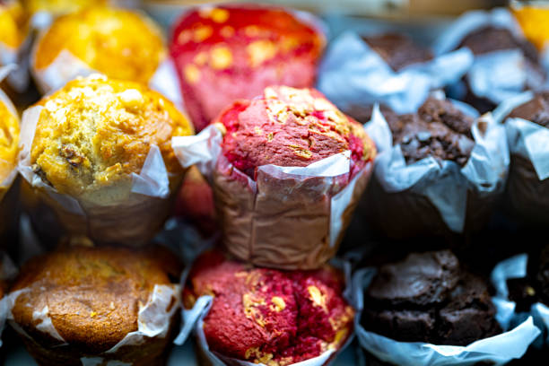 Different types of muffins for sale in a bakery.