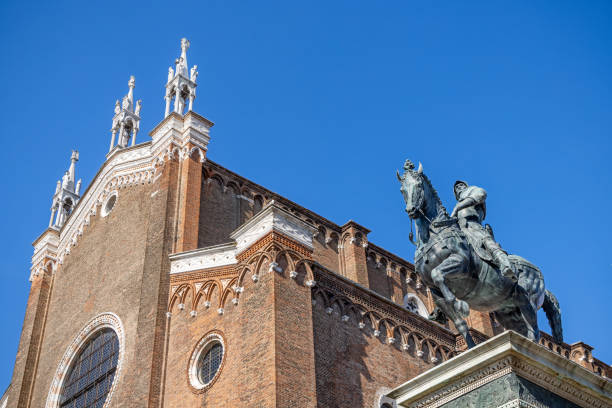 Basilica dei Santi Giovanni e Paolo, Venice, Italy - June 1th 2024:  Statue of Bartolomeo Colleoni (1400-1475) made of Andrea del Verrocchio in 1488 in front of the basilica which has a long history, the building where completed in 1430 and has since in periods been the burial place for the dodges of Venezia