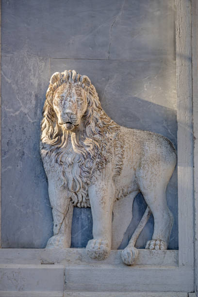 Turin, Piedmont, Italy - December 22 2024: Detail of a statue on the facade of Great Mother of God Church with a lion, symbol of St Mark the Evangelist, created by Carlo Chelli (1807-1877) in 1885.