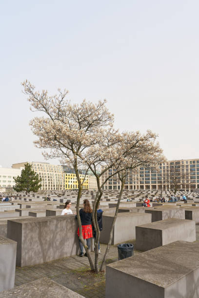Berlin, Germany – March 30, 2024: Visitors at the Holocaust Memorial to the Murdered Jews of Europe in the center of Berlin