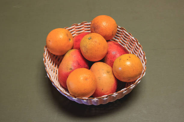 tray of peaches and oranges on a green table