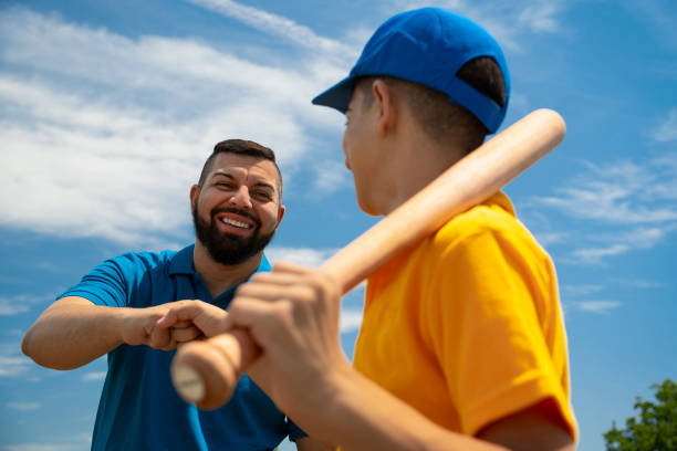 istock Father and son with a baseball bat ready 2157818609