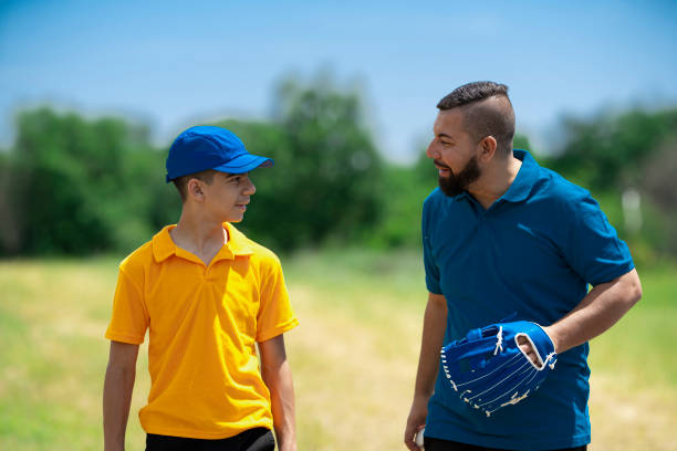 istock Father and son talking with baseball glove 2157818622