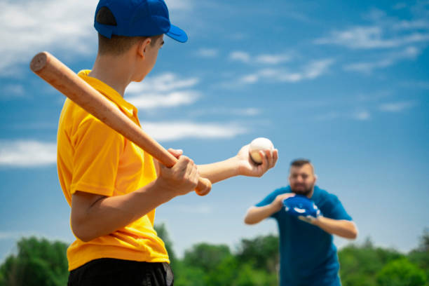 istock Father pitching to son in baseball practice 2157818629