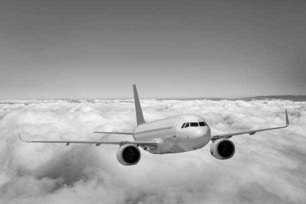 Passenger jet airplane flying above clouds