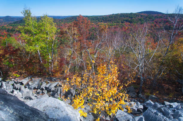 A aerial view of the mountains around becket quarry in massachusetts on an autumn day.