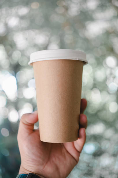 istock Hand holding brown paper cup for hot tea or hot coffee 2157820943