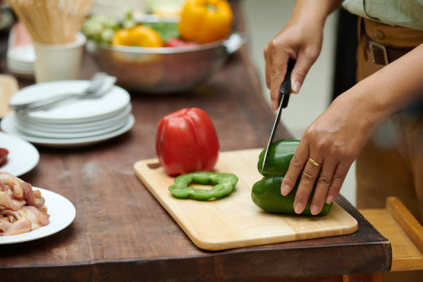 istock Woman Cutting Bell Pepper 2157824972