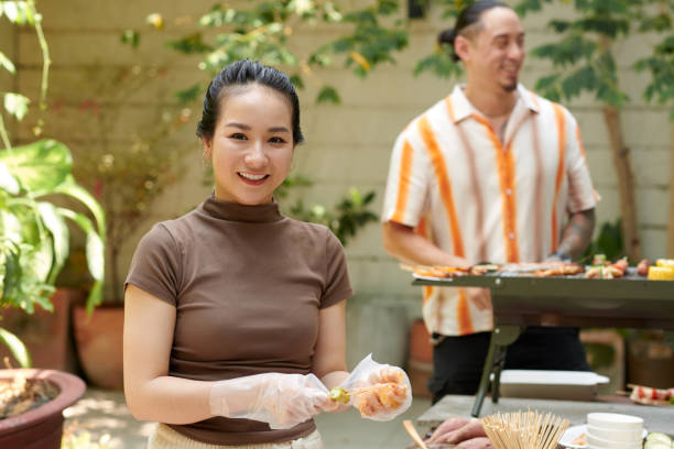istock Woman Making Kebab for Friends 2157824999