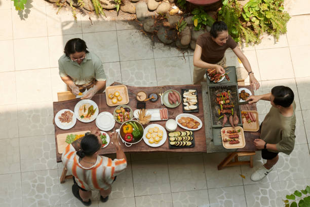 istock Friends Cooking Dinner in Backyard 2157825003