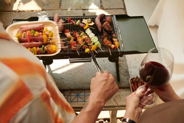 istock Couple Cooking Kebabs in Backyard 2157825061