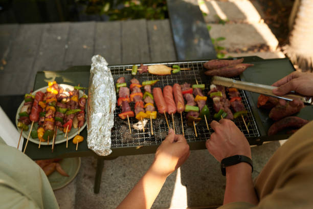istock Couple Grilling Meat Kebabs 2157825117