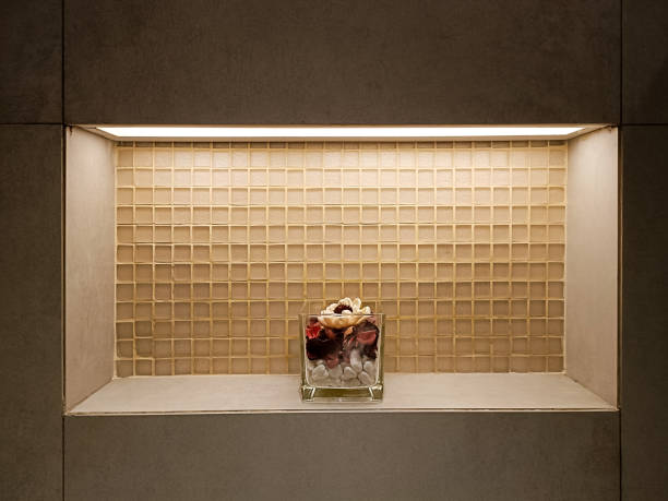 Aesthetic Wall Niche with Subtle Lighting and Elegant Floral Arrangement in a Modern Interior with Beige Tiled Background and Minimalist Design