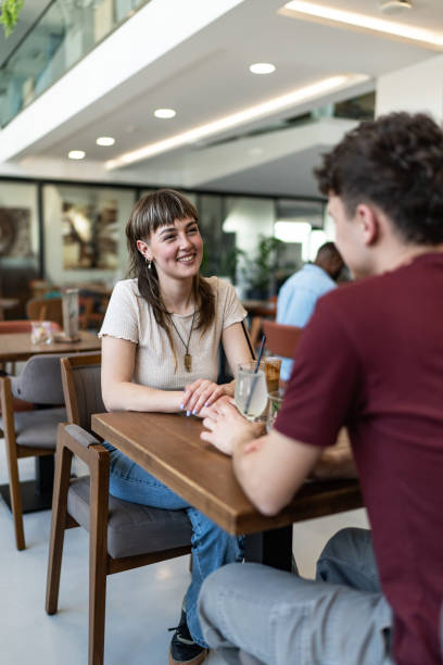 istock Happy young couple sitting in cafe 2157826889
