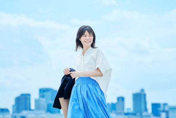 A young woman in casual clothes going to work under clear sky
