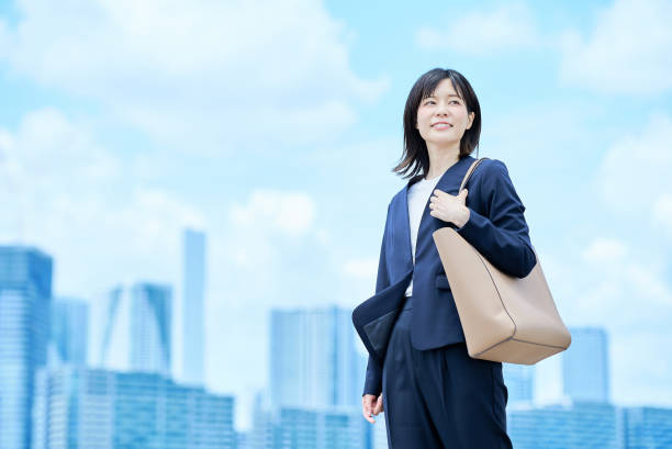 istock A young woman in a suit commuting to work 2157833654