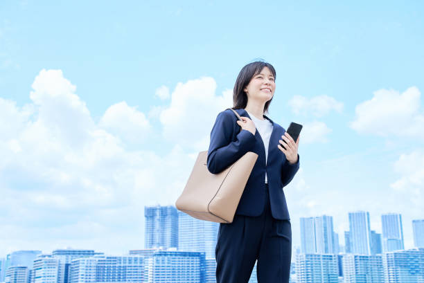 istock A young woman in a suit commuting to work 2157833736