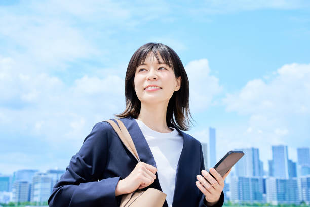 istock A young woman in a suit commuting to work 2157833770