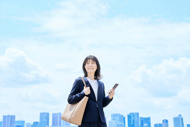istock A young woman in a suit commuting to work 2157833785