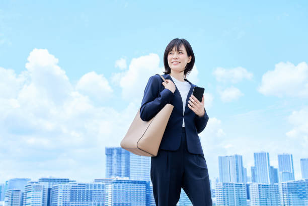 istock A young woman in a suit commuting to work 2157833811